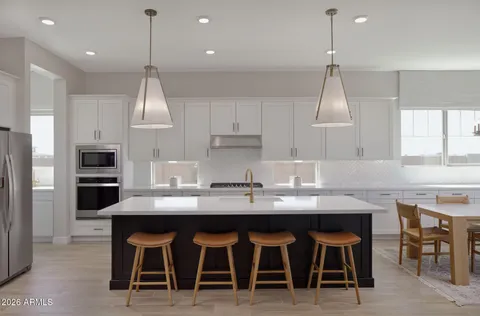 a kitchen with kitchen island granite countertop a sink and stove