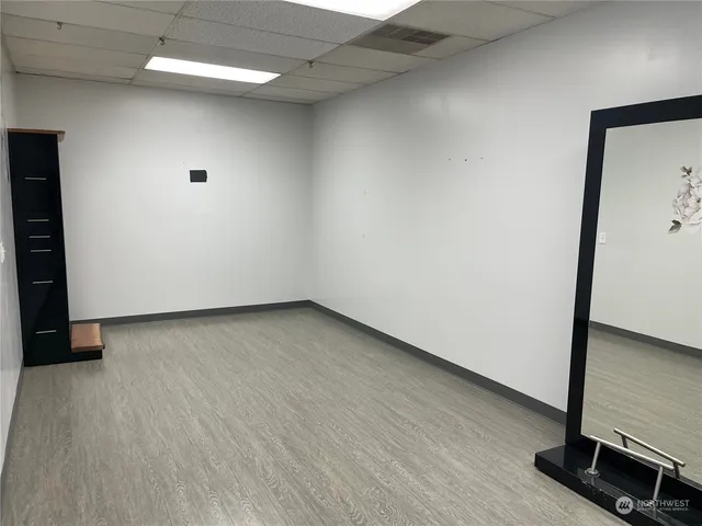 a view of a livingroom with an empty space and a window