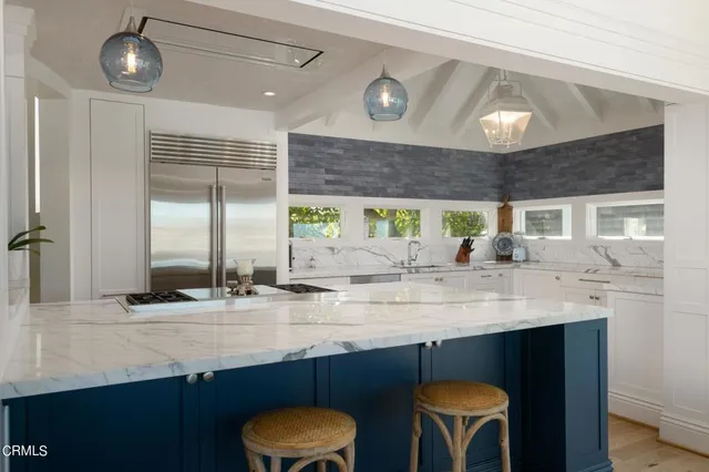 a kitchen with a sink a counter space and appliances