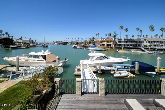 a lake view with boat and palm trees
