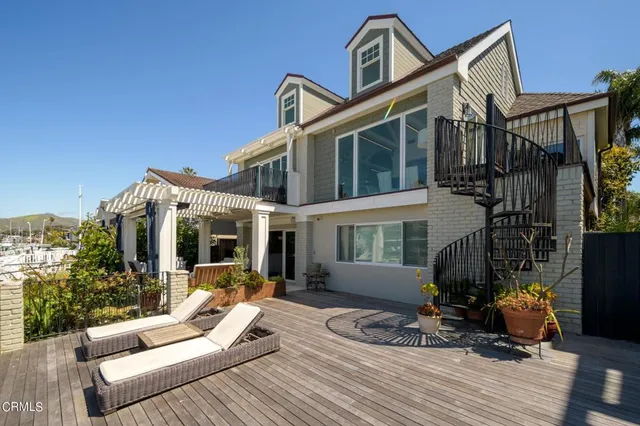 a view of a patio with couches table and chairs and potted plants