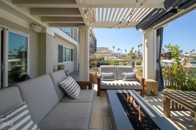 a balcony with furniture and a potted plant