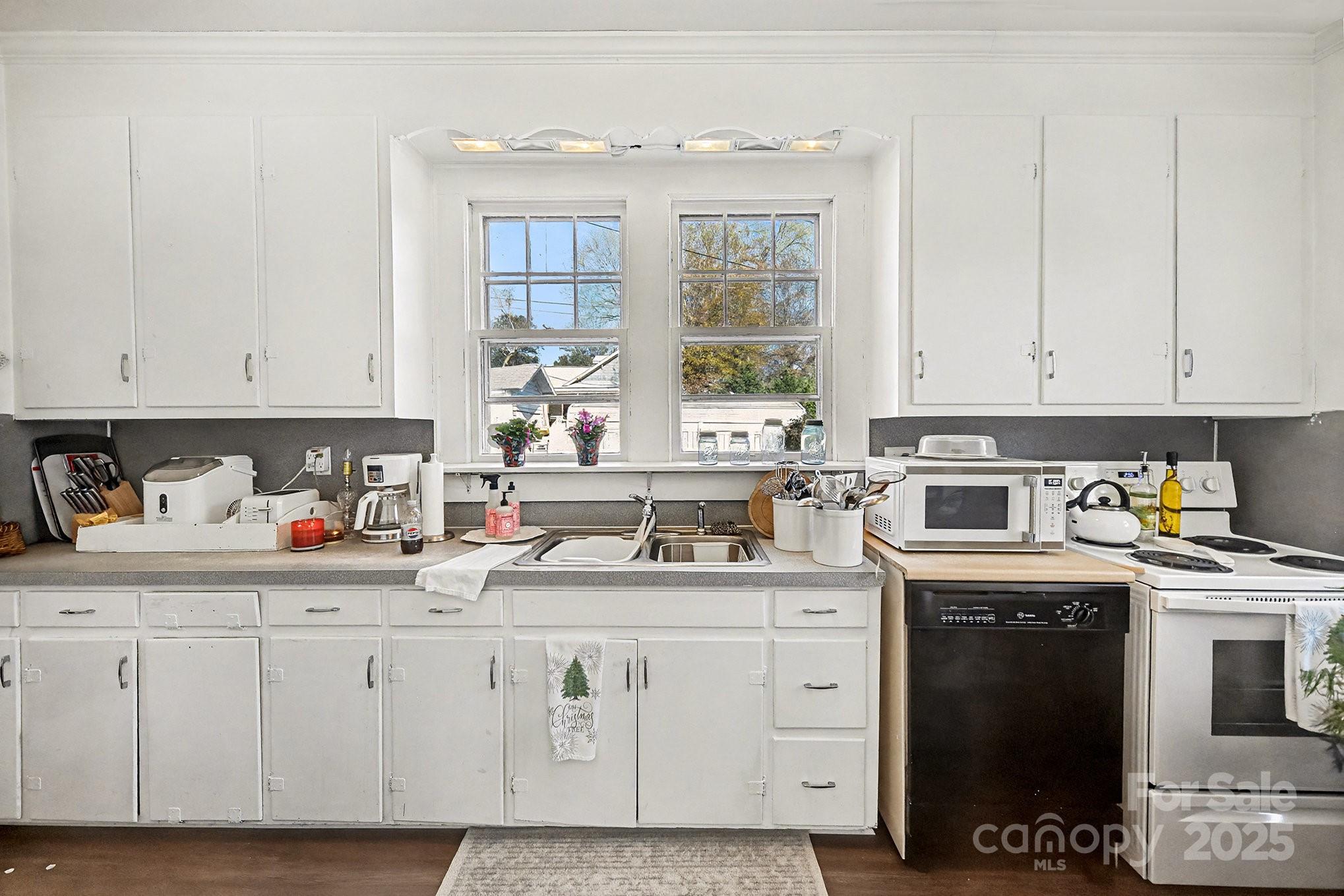 352 Kerr Street Northwest Concord, NC 28025 - Photo 21 of 41 a kitchen with stainless steel appliances granite countertop a sink a stove and cabinets