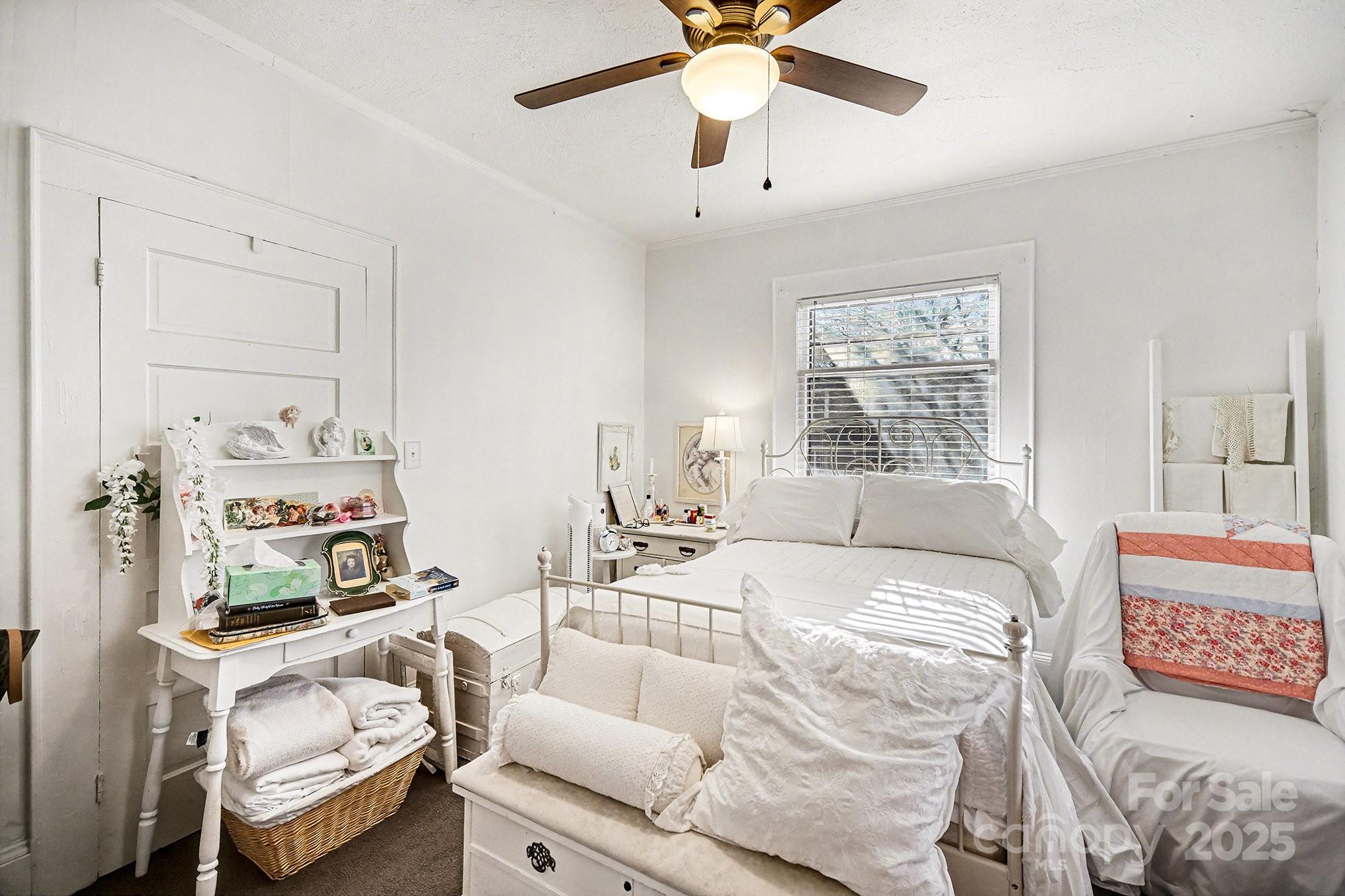 352 Kerr Street Northwest Concord, NC 28025 - Photo 29 of 41 a bedroom with a bed and a chandelier