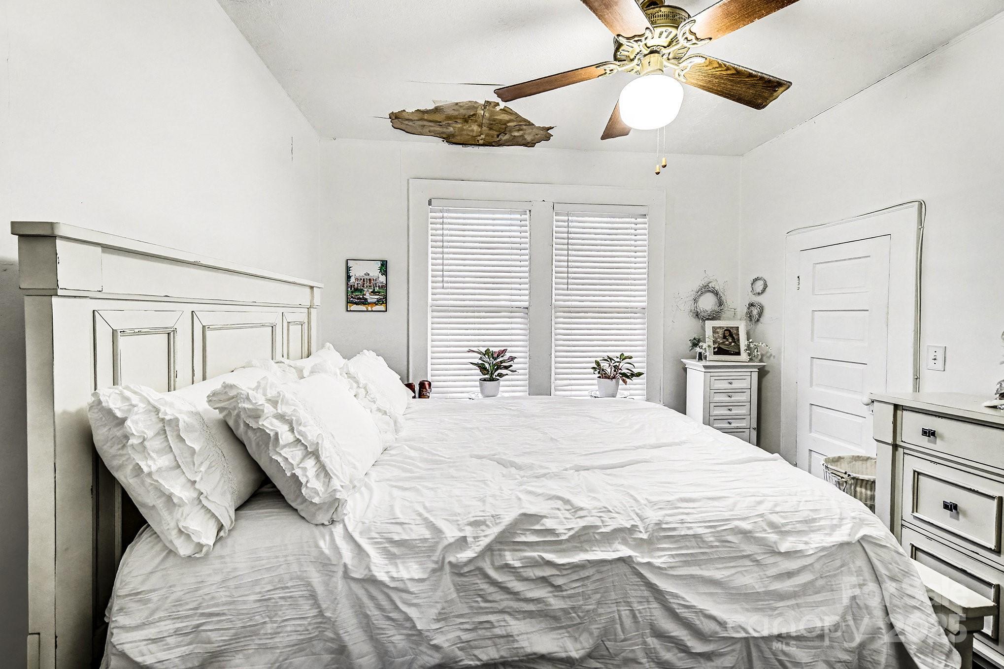 352 Kerr Street Northwest Concord, NC 28025 - Photo 30 of 41 a bedroom with a large bed and a chandelier