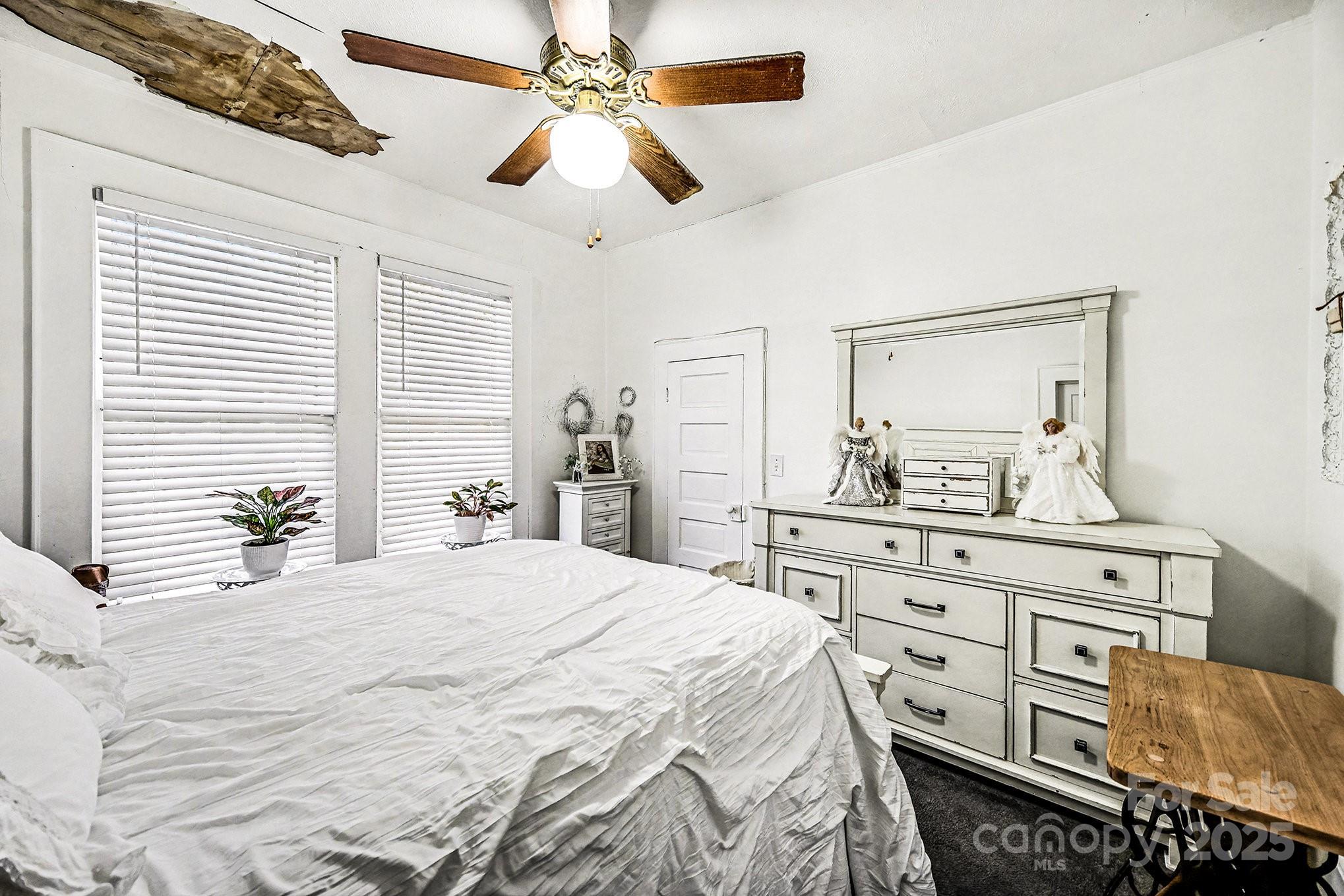 352 Kerr Street Northwest Concord, NC 28025 - Photo 31 of 41 a bedroom with a bed a chandelier and dresser