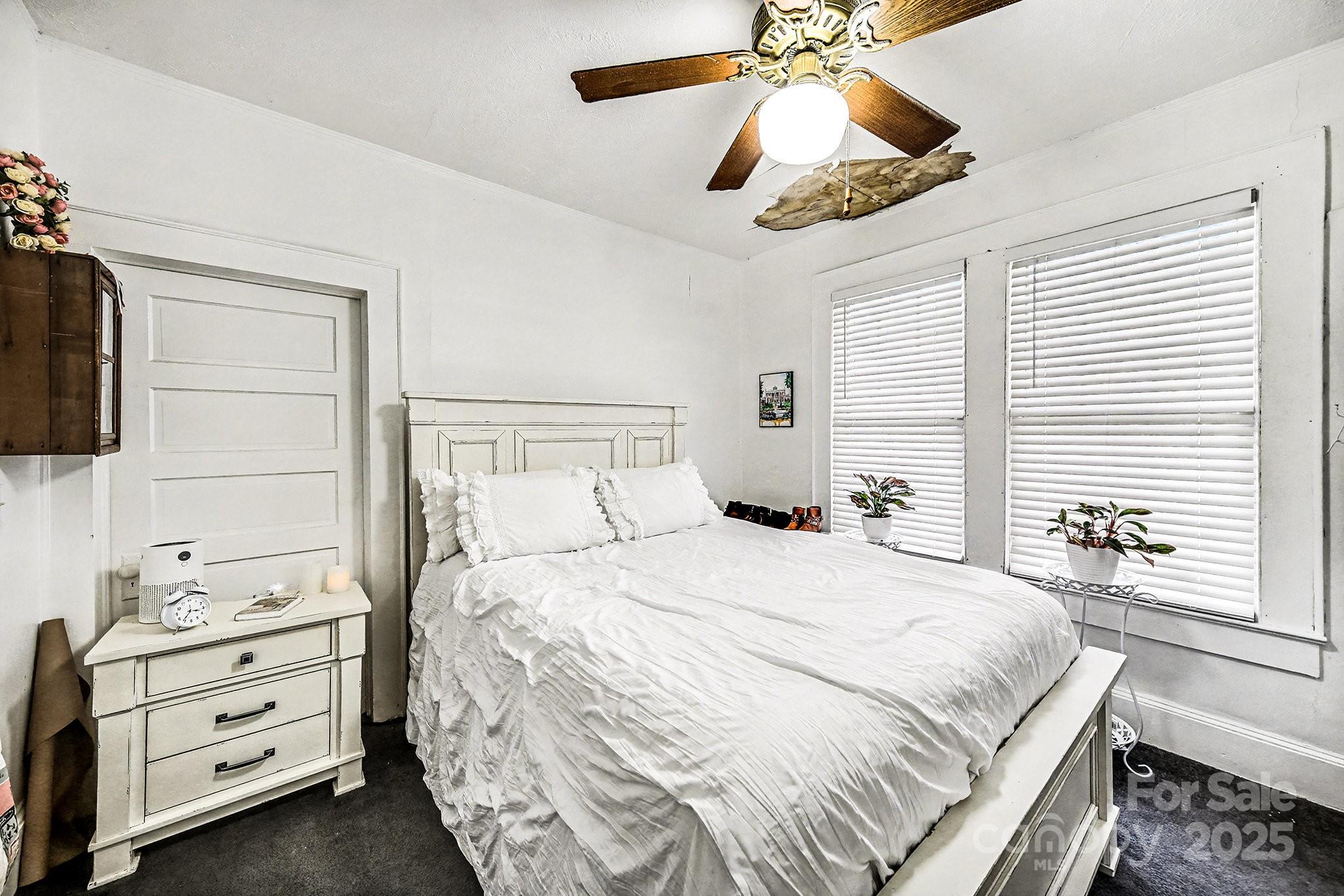352 Kerr Street Northwest Concord, NC 28025 - Photo 32 of 41 a bedroom with a bed and a chandelier