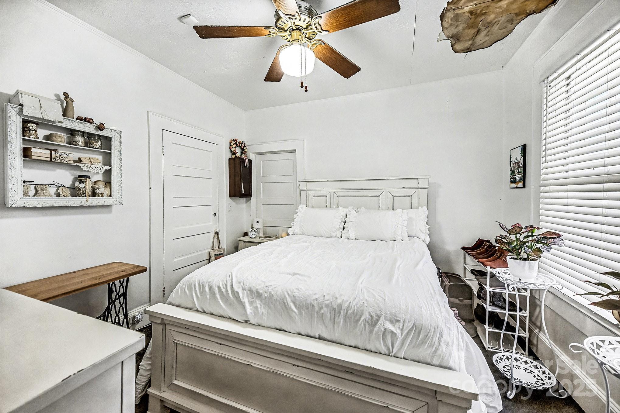 352 Kerr Street Northwest Concord, NC 28025 - Photo 34 of 41 a bedroom with a bed and a chandelier