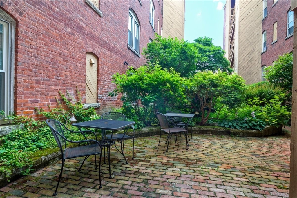 6 Chatham Place, Unit 6 Worcester, MA 01609 - Photo 28 of 31 a view of a backyard with plants and a bench