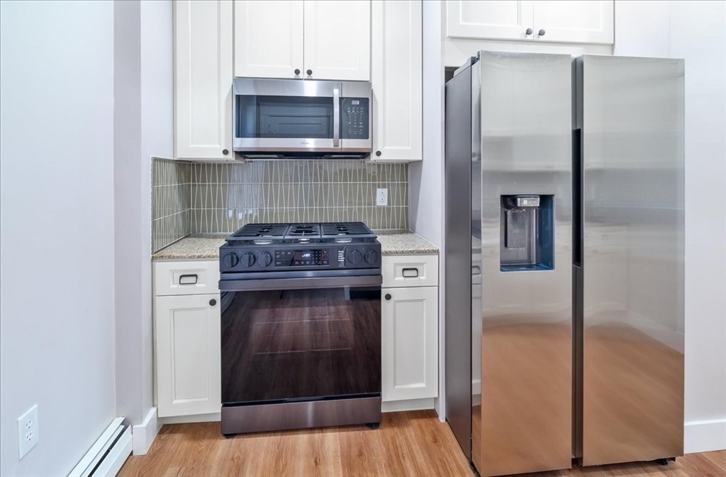6 Chatham Place, Unit 6 Worcester, MA 01609 - Photo 6 of 31 a kitchen with a refrigerator and a stove
