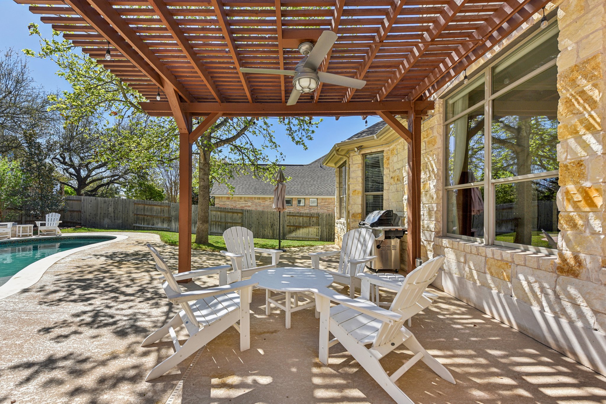 12913 Little Dipper Path Austin, TX 78732 - Photo 21 of 30 a view of a patio with table and chairs potted plants and floor to ceiling window