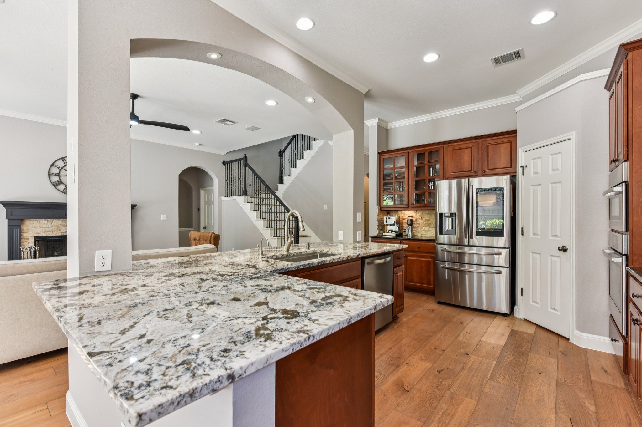 12913 Little Dipper Path Austin, TX 78732 - Photo 4 of 30 a kitchen with stainless steel appliances granite countertop a sink stove and refrigerator