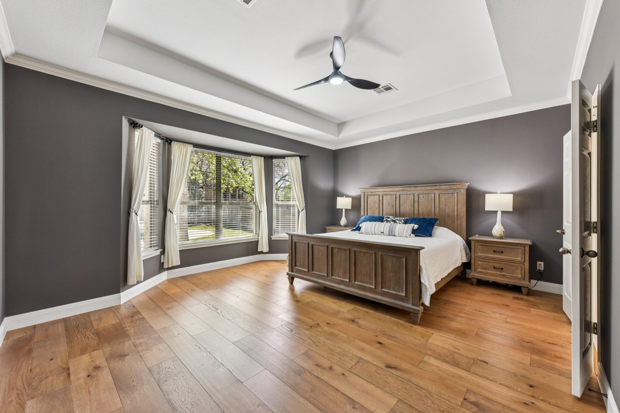 12913 Little Dipper Path Austin, TX 78732 - Photo 7 of 30 a bedroom with a large bed and a large window