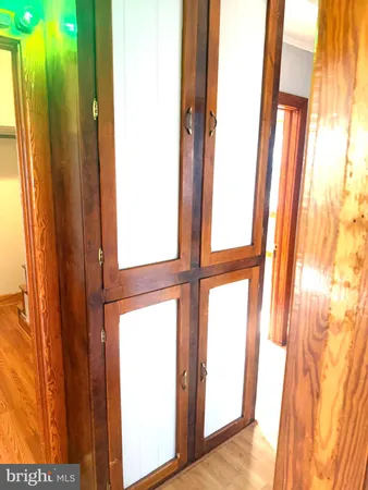 a view of a room with wooden floor and bench