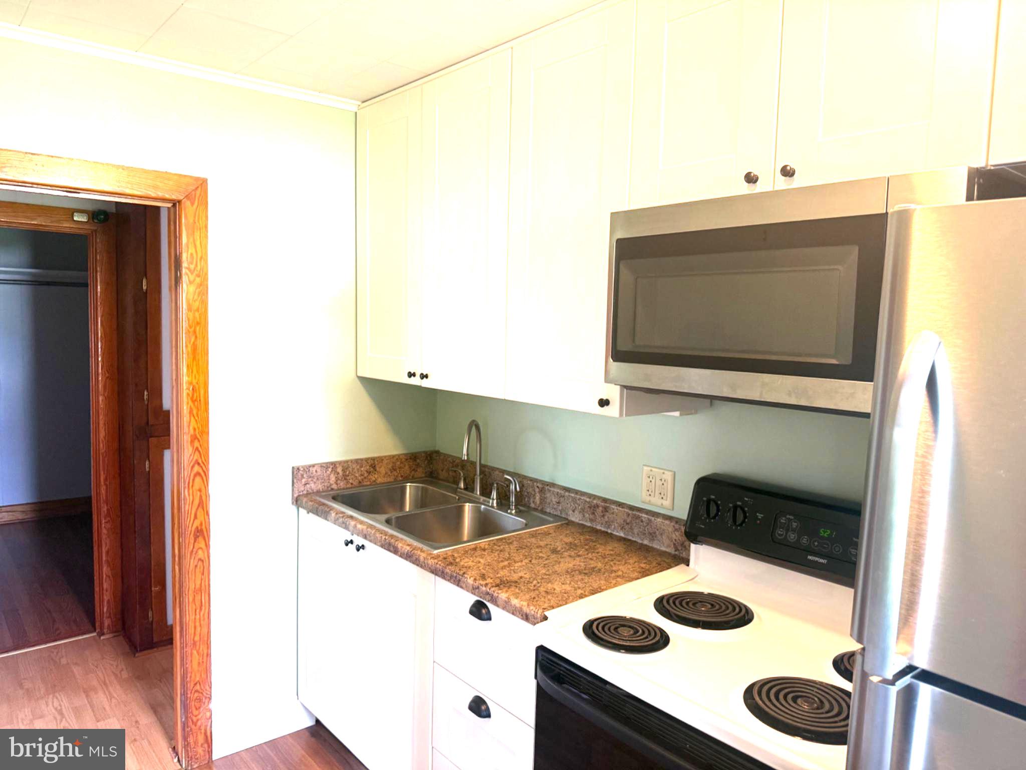 10899 Fish And Game Road, Unit 2 Waynesboro, PA 17268 - Photo 19 of 24 a kitchen with a stove and a microwave