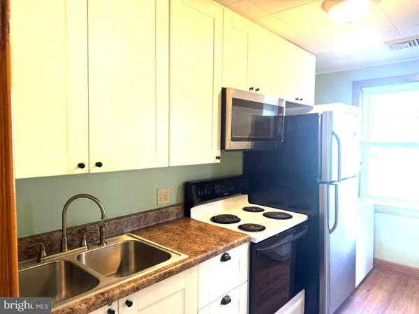 a kitchen with a refrigerator sink and stove