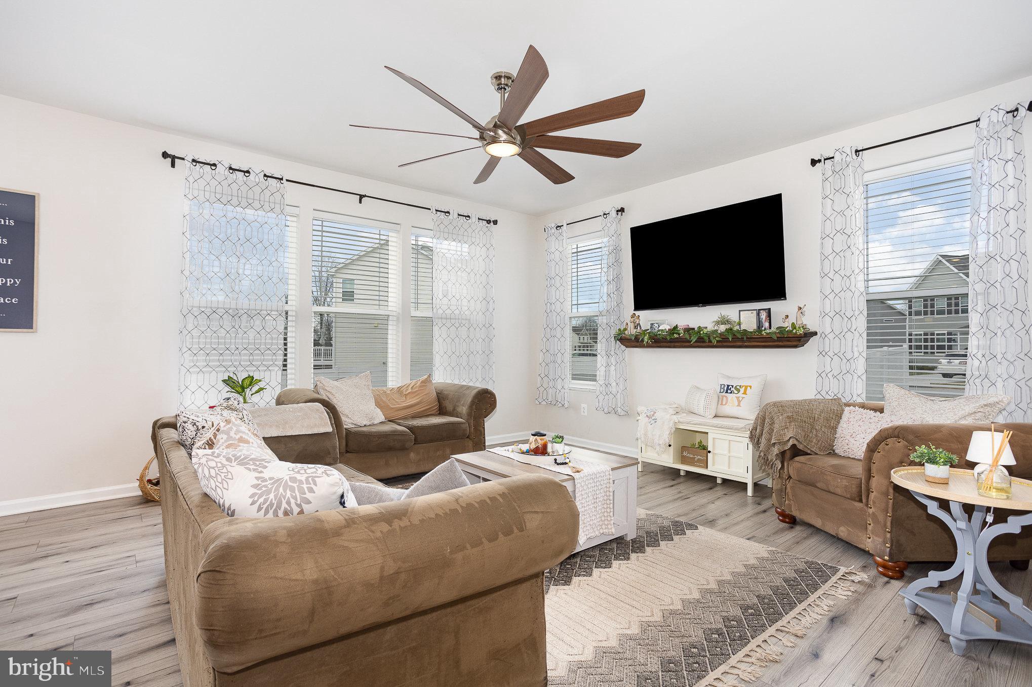 10 Beech Ridge Lane York, PA 17404 - Photo 9 of 47 a living room with furniture a flat screen tv and a large window