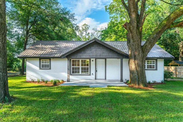 a view of house with yard