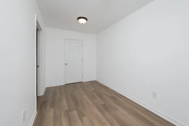 an empty room with wooden floor