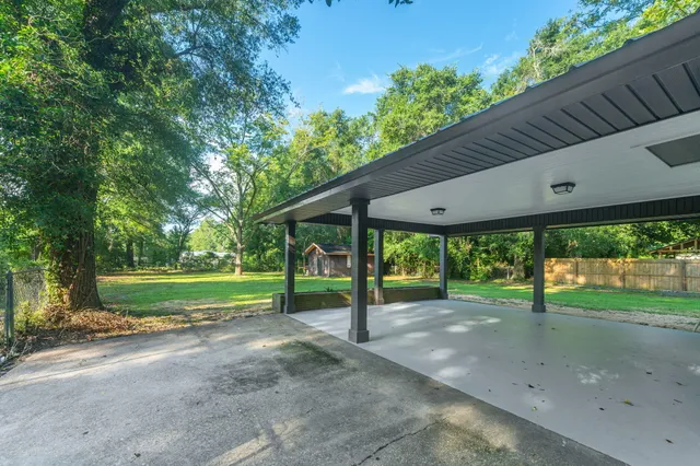 a view of a house with backyard and a backyard