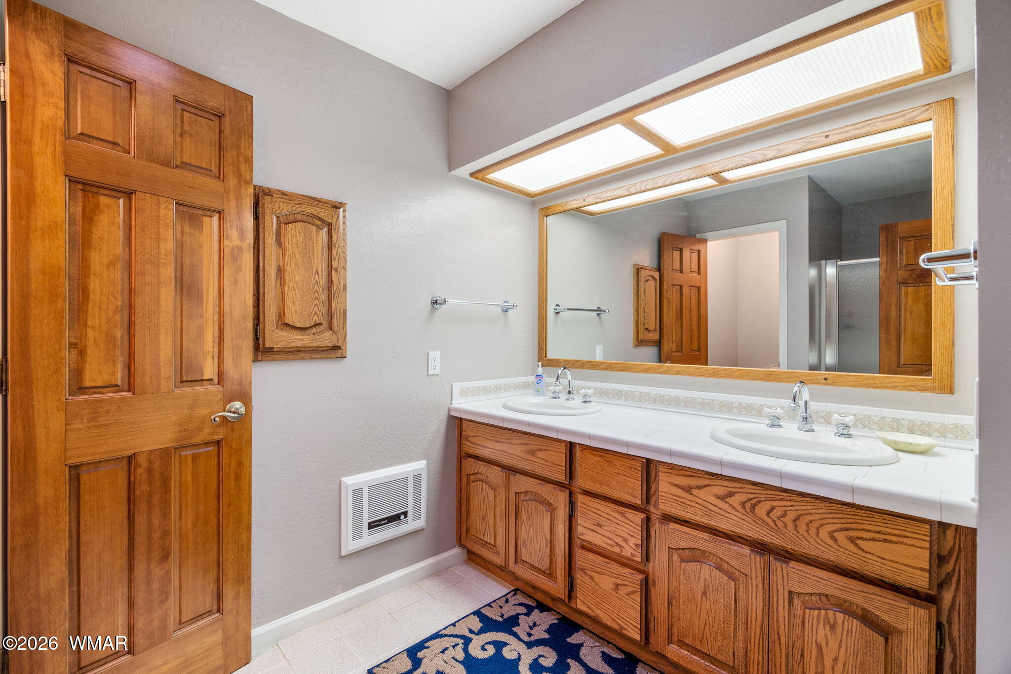 2922 Pine Rim Road Overgaard, AZ 85933 - Photo 26 of 58 a spacious bathroom with a double vanity sink a mirror and a shower