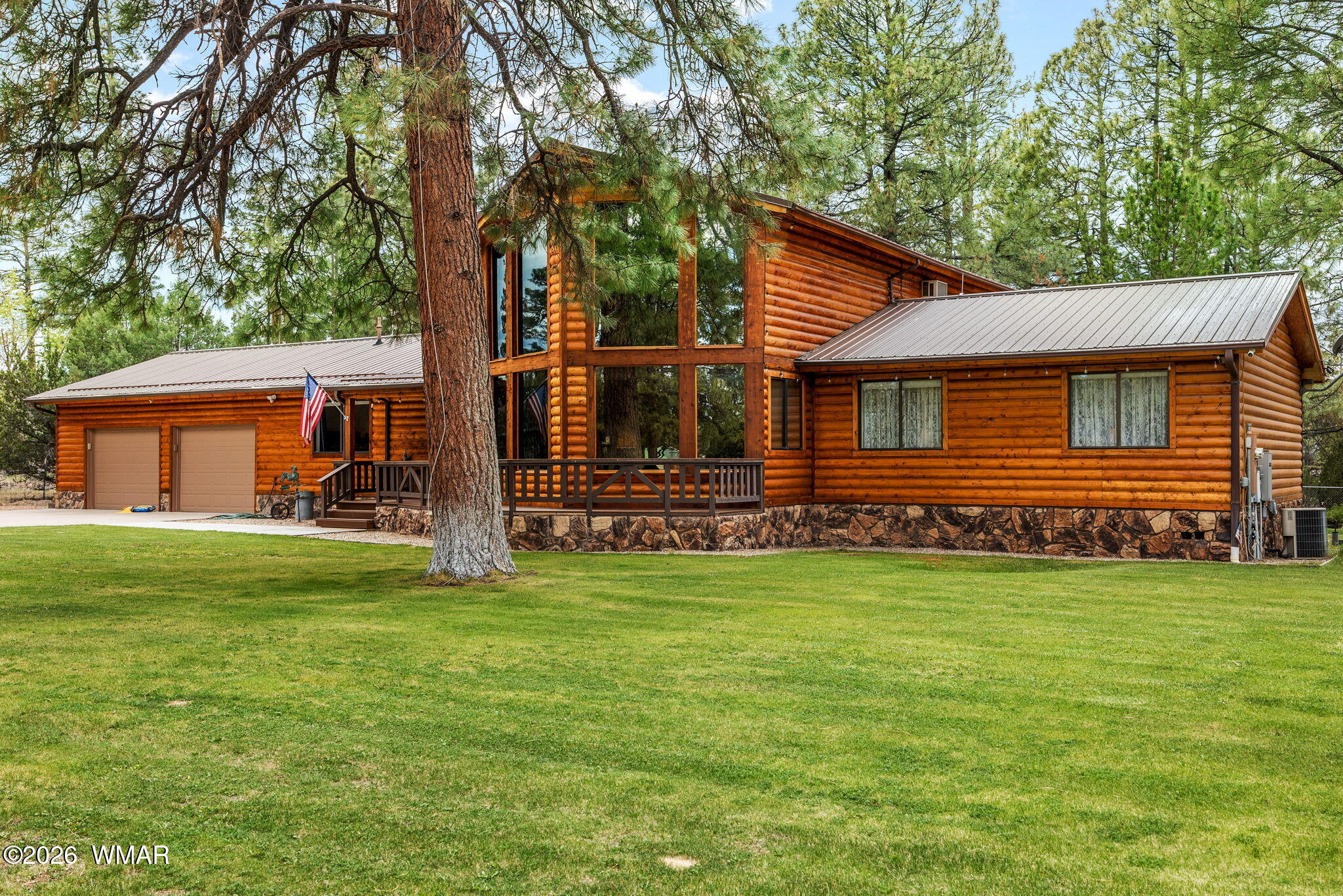 2922 Pine Rim Road Overgaard, AZ 85933 - Photo 3 of 58 a front view of a house with a garden