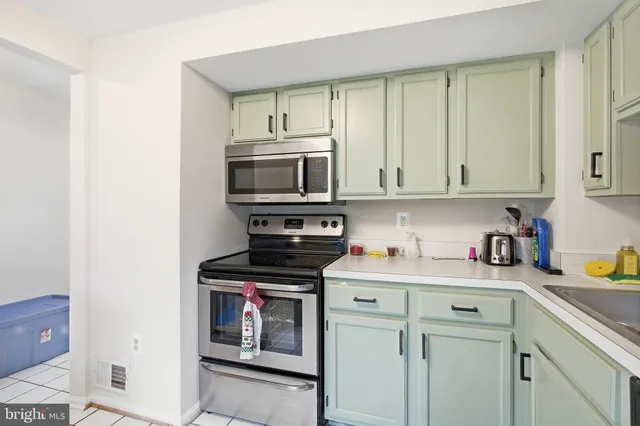 a kitchen with stainless steel appliances granite countertop a sink and a stove top oven