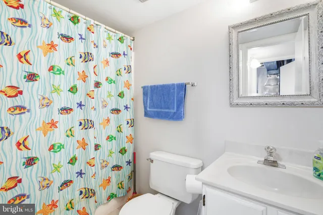 a bathroom with a sink and mirror with toilet
