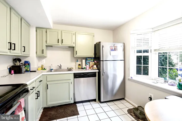 a kitchen with stainless steel appliances a refrigerator sink and cabinets