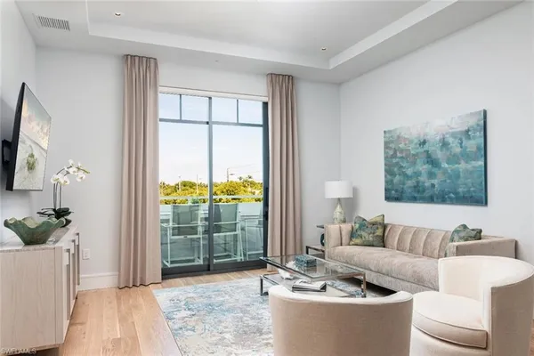 a living room with furniture and a large window
