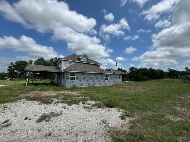 a view of outdoor space with green field and trees all around