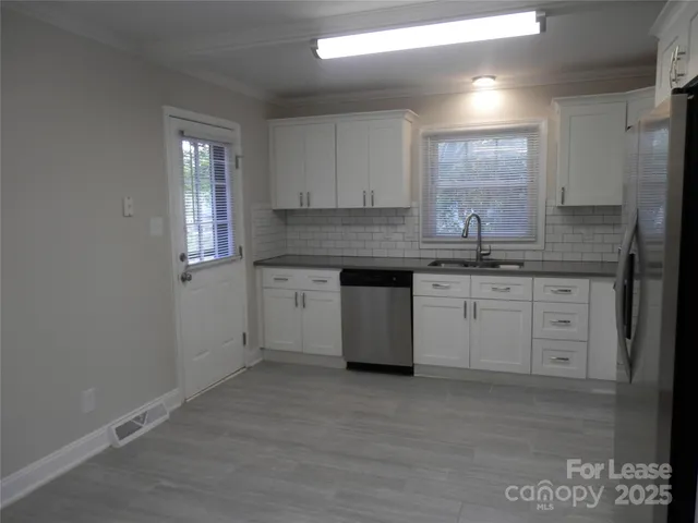 a kitchen with a sink stove and cabinets