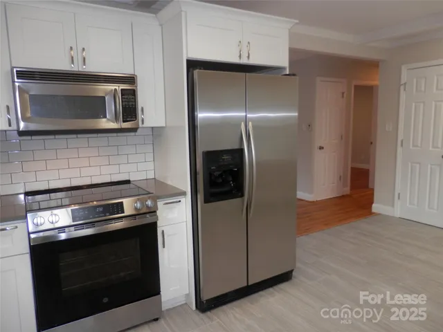 a kitchen with cabinets and stainless steel appliances