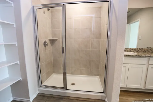 a bathroom with a glass shower door