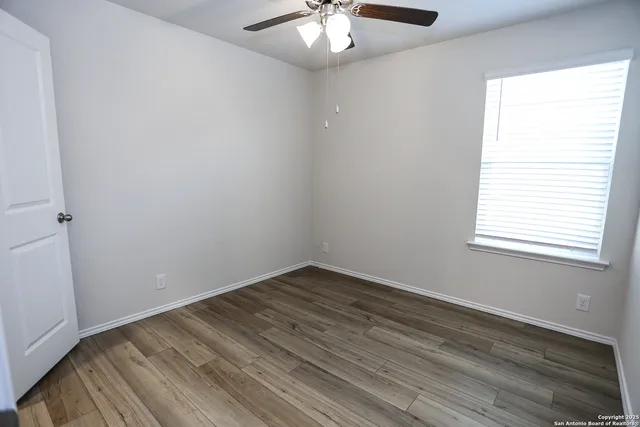wooden floor in an empty room with a window