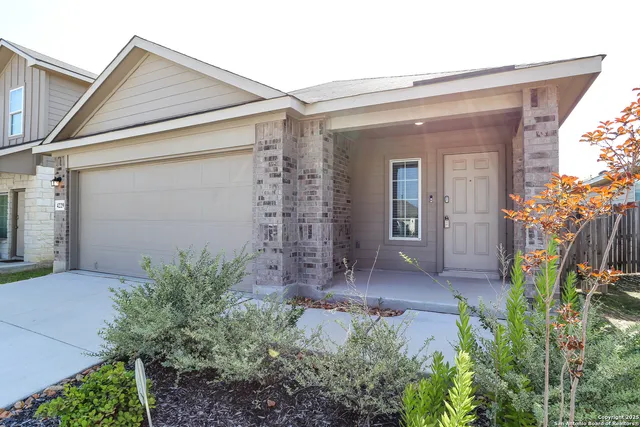 a view of a small house with potted plants