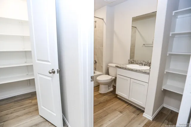 a bathroom with a toilet sink and a mirror