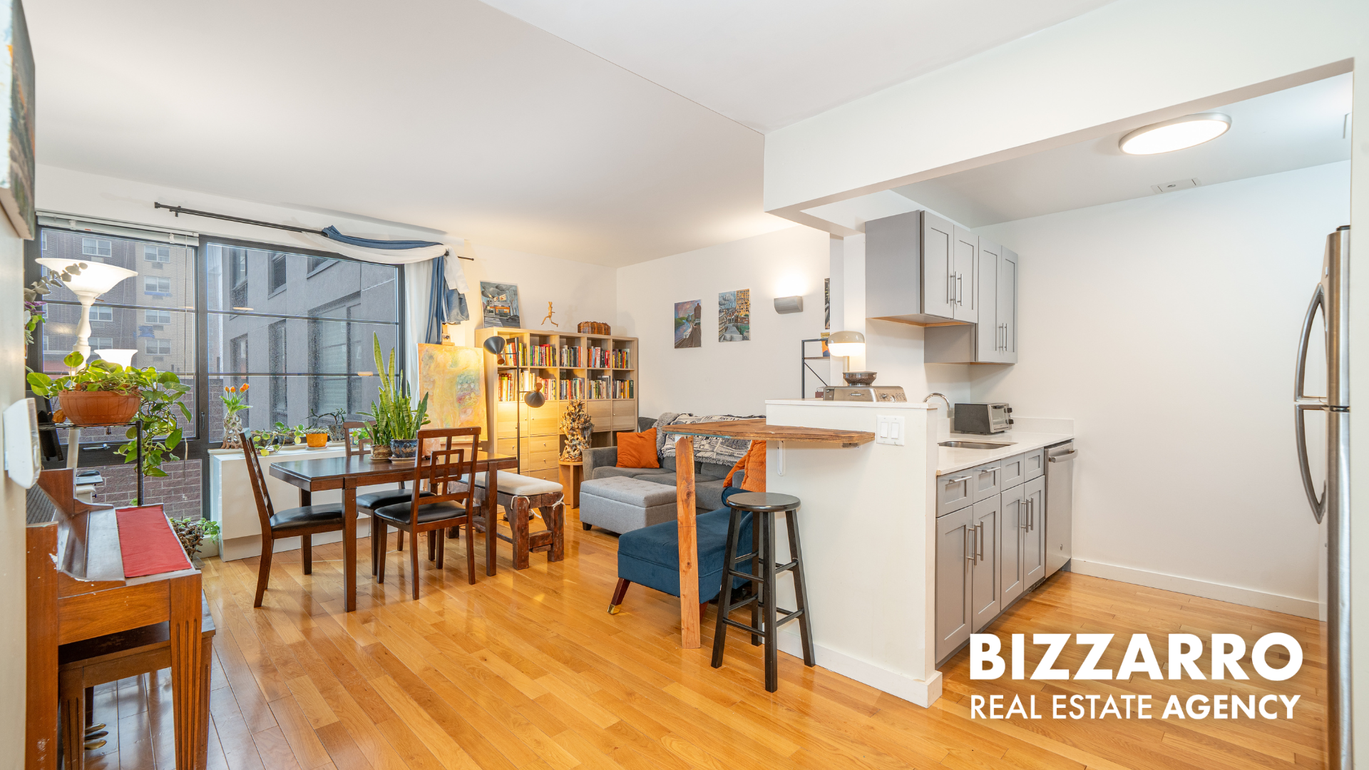 a kitchen with stainless steel appliances granite countertop a table chairs and a refrigerator