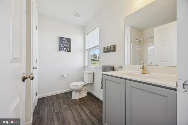 a bathroom with a sink toilet and a mirror