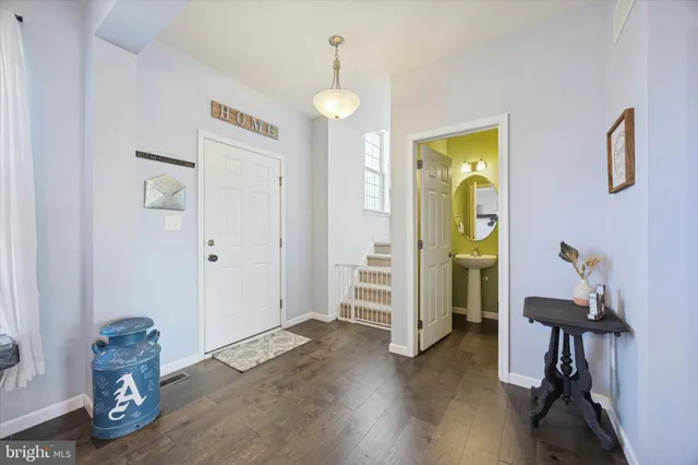 a view of a room with wooden floor and furniture