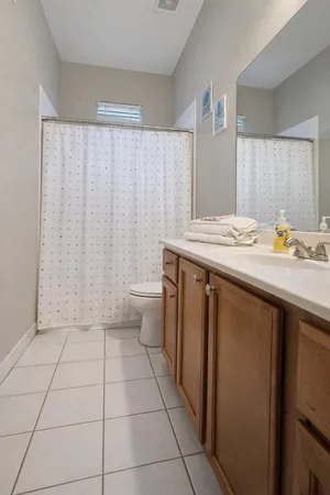 a utility room with a sink a toilet and a mirror