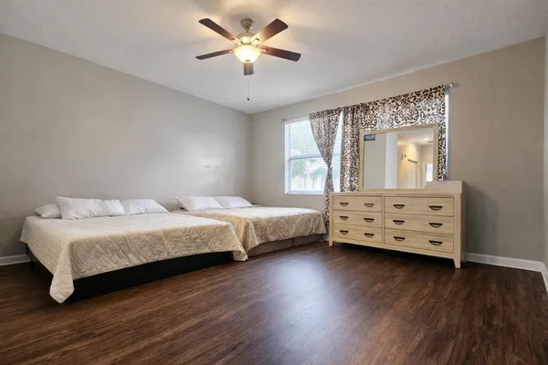 a bedroom with a bed and a tv on the dresser