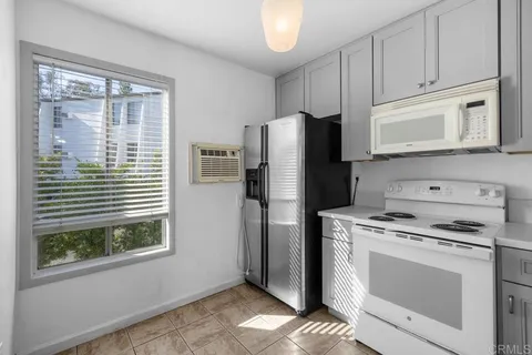a kitchen with appliances cabinets and a window