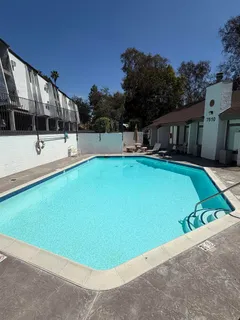 a view of a house with swimming pool and porch