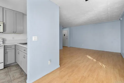 a view of a kitchen with white cabinets