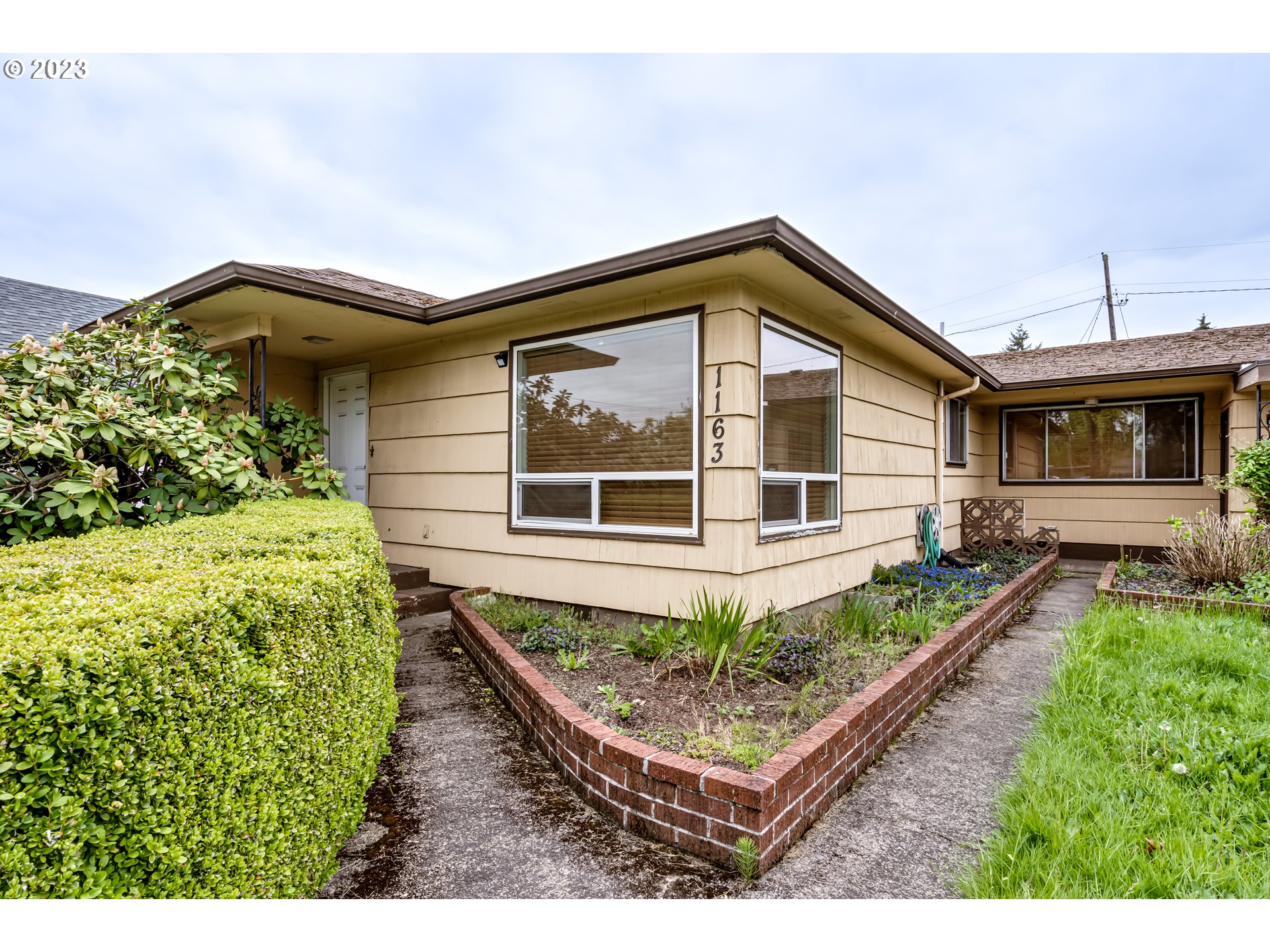 1163 D Street Springfield, OR 97477 - Photo 1 of 37 a house view with a garden space