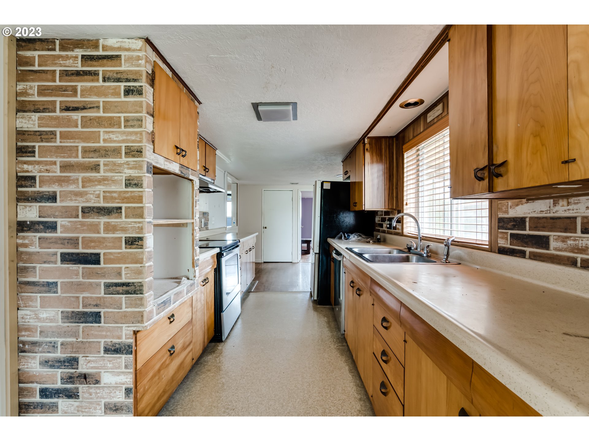 1163 D Street Springfield, OR 97477 - Photo 11 of 37 a kitchen with cabinets and a stove