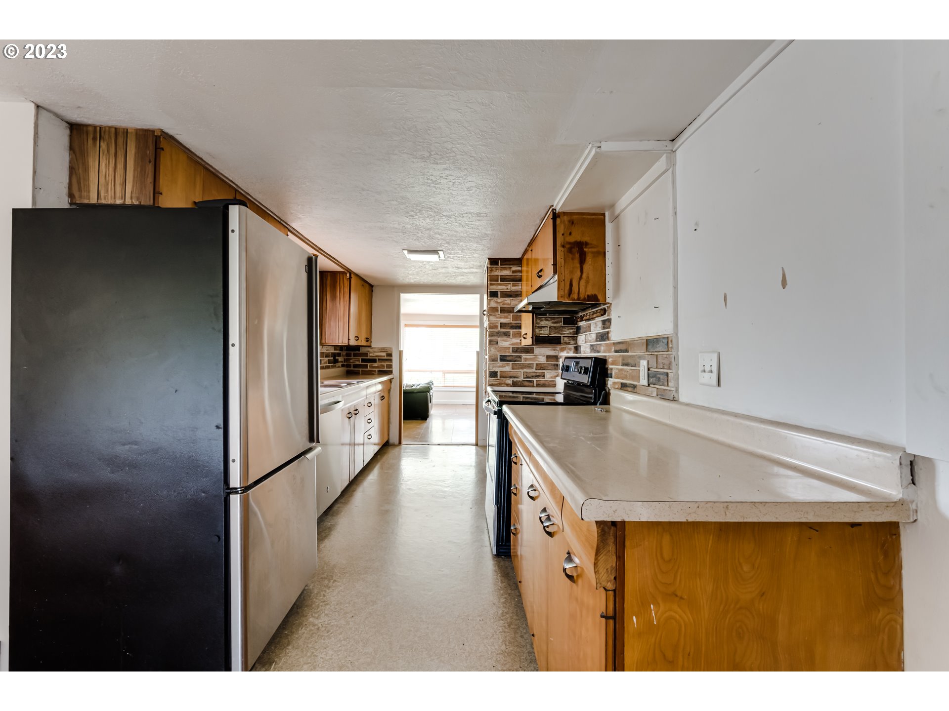 1163 D Street Springfield, OR 97477 - Photo 13 of 37 a kitchen with kitchen island a counter top space a sink and appliances