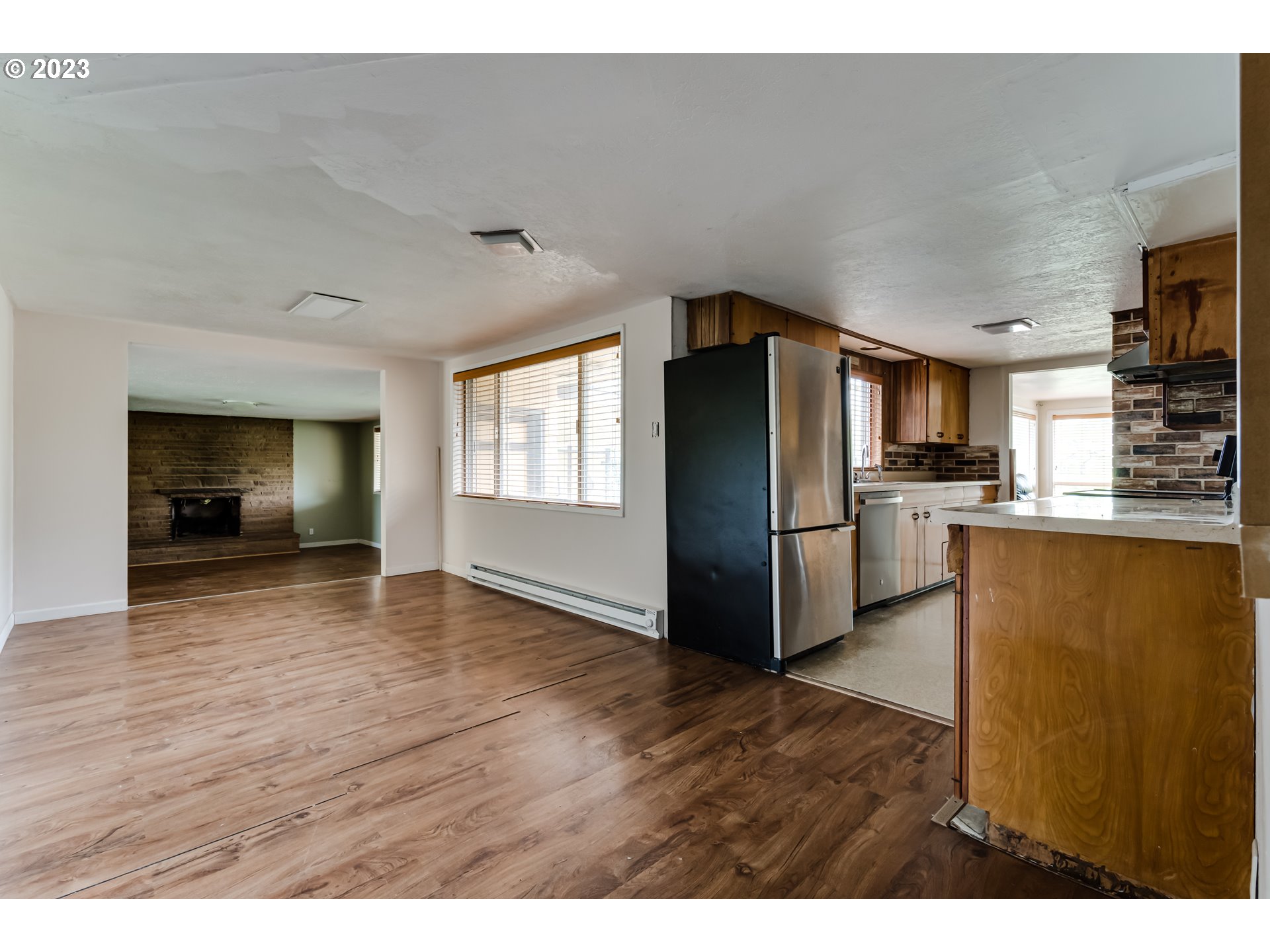 1163 D Street Springfield, OR 97477 - Photo 14 of 37 a kitchen with stainless steel appliances granite countertop a refrigerator a stove and a wooden floors