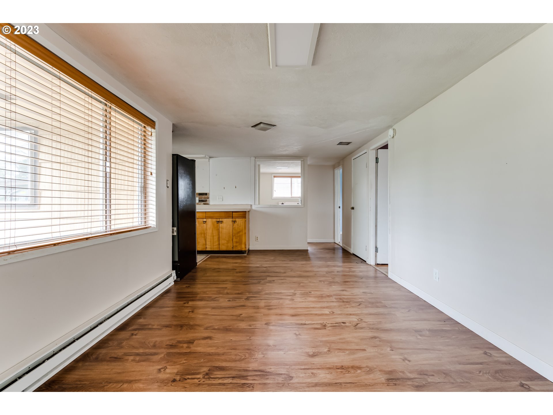 1163 D Street Springfield, OR 97477 - Photo 15 of 37 a view of an empty room with window and wooden floor